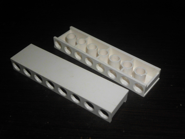 Brick Special 2 x 8 x 5/6 with No Top Studs, and Channel on Ends, and Stud Holes on Sides in White