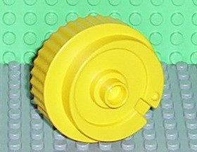 Duplo Counterweight 3 x 3 x 2 Round, Notched Rim, Off-Center Swirl and One Stud in Yellow